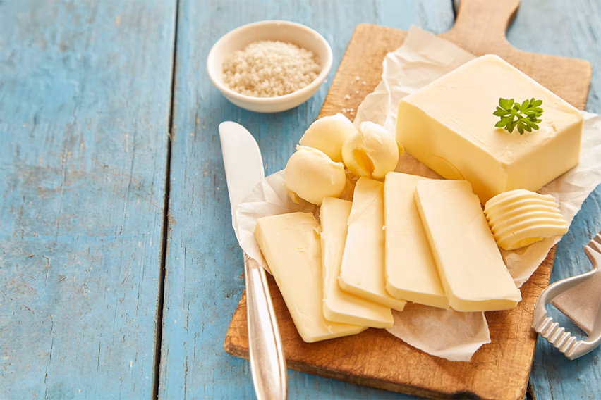Butter slices and bar on a wooden board